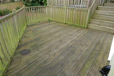 A picture of a dirty, unstained deck in need of cleaning.